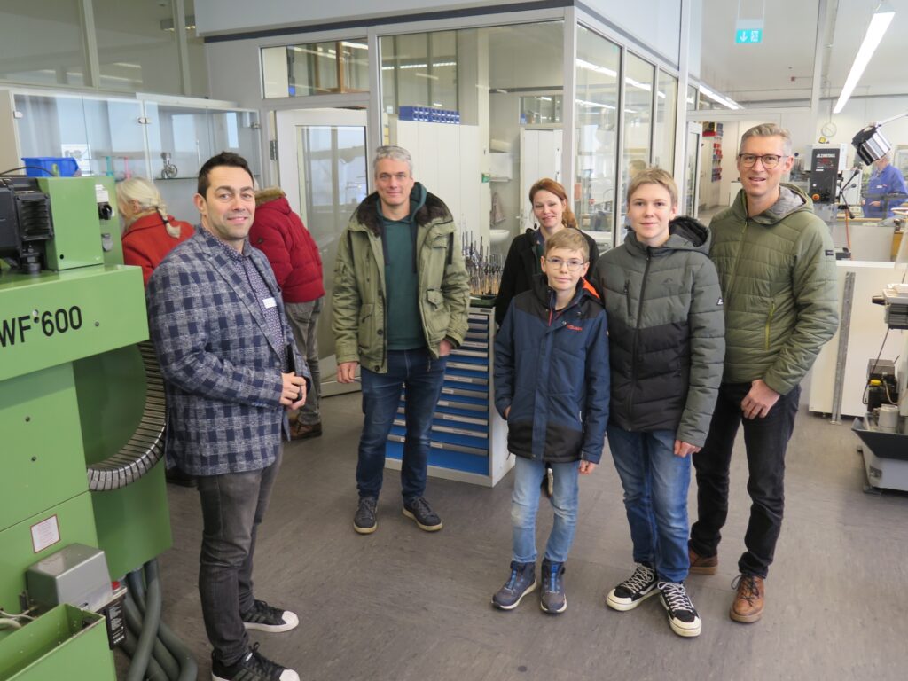 15 Lehrer Grießhaber mit Besuchern in Mechanikerwerkstatt